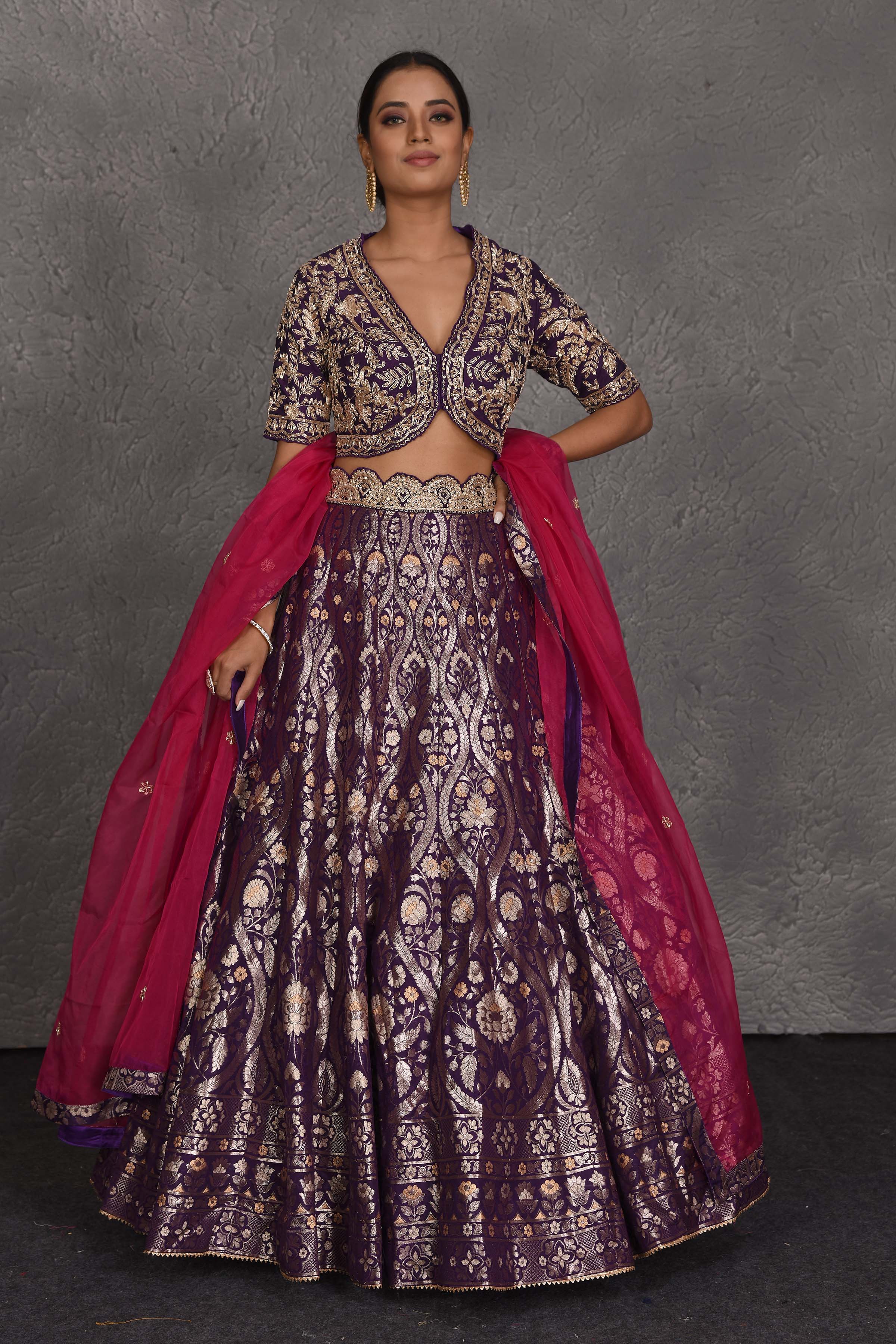 Shop purple hand embroidered Banarasi lehenga online in USA with pink dupatta. Flaunt your Indian style on festive occasions in stunning designer lehengas, Anarkali suit, sharara suits, designer gowns, designer sarees, embroidered sarees from Pure Elegance India fashion store in USA. -full view