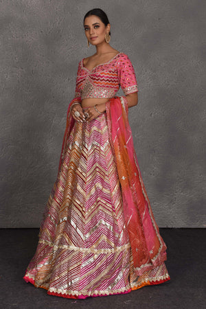 Buy stunning pink heavy gota lace work designer lehenga online in USA with dupatta. Flaunt your Indian style on festive occasions in stunning designer lehengas, Anarkali suit, sharara suits, designer gowns, designer sarees, embroidered sarees from Pure Elegance India fashion store in USA. -side