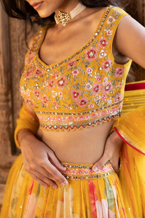 Shop beautiful yellow embroidered floral georgette lehenga online in USA with dupatta. Dazzle on weddings and special occasions with exquisite Indian designer dresses, sharara suits, Anarkali suits, bridal lehengas, sharara suits from Pure Elegance Indian clothing store in USA.-closeup