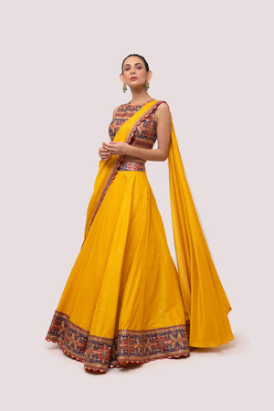 Shop the Look your best on wedding occasions in this mustard color lehenga with the multicolor blouse and a beautiful dupatta. Dazzle on weddings and special occasions with exquisite Indian designer dresses, sharara suits, Anarkali suits, bridal lehengas, and sharara suits from Pure Elegance Indian clothing store in the USA. Shop online from Pure Elegance.