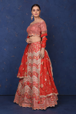 Buy red embroidered off-shoulder lehenga online in USA with dupatta, Be the center of attraction on festive occasions in beautiful designer suits, dresses, lehengas, designer gowns, from Pure Elegance Indian fashion store in USA.-side