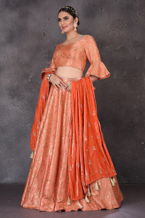 Shop stunning orange Banarasi  designer lehenga online in USA with dupatta. Look elegant at weddings and festive occasions in exclusive designer suits, designer gowns, Anarkali suits, sharara suits, wedding gowns, palazzo suits, designer lehenga from Pure Elegance Indian clothing store in USA.-side