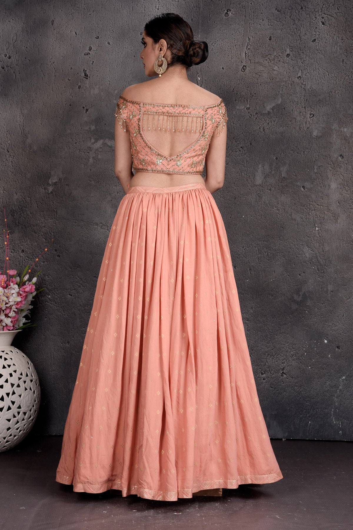 Shop beautiful peach off-shoulder designer lehenga online in USA with attached dupatta. Set a fashion statement at parties in designer Indian suits, Anarkali suits, designer lehengas, gowns, Indowestern dresses from Pure Elegance Indian fashion store in USA.-back