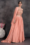 Shop beautiful peach off-shoulder designer lehenga online in USA with attached dupatta. Set a fashion statement at parties in designer Indian suits, Anarkali suits, designer lehengas, gowns, Indowestern dresses from Pure Elegance Indian fashion store in USA.-full view