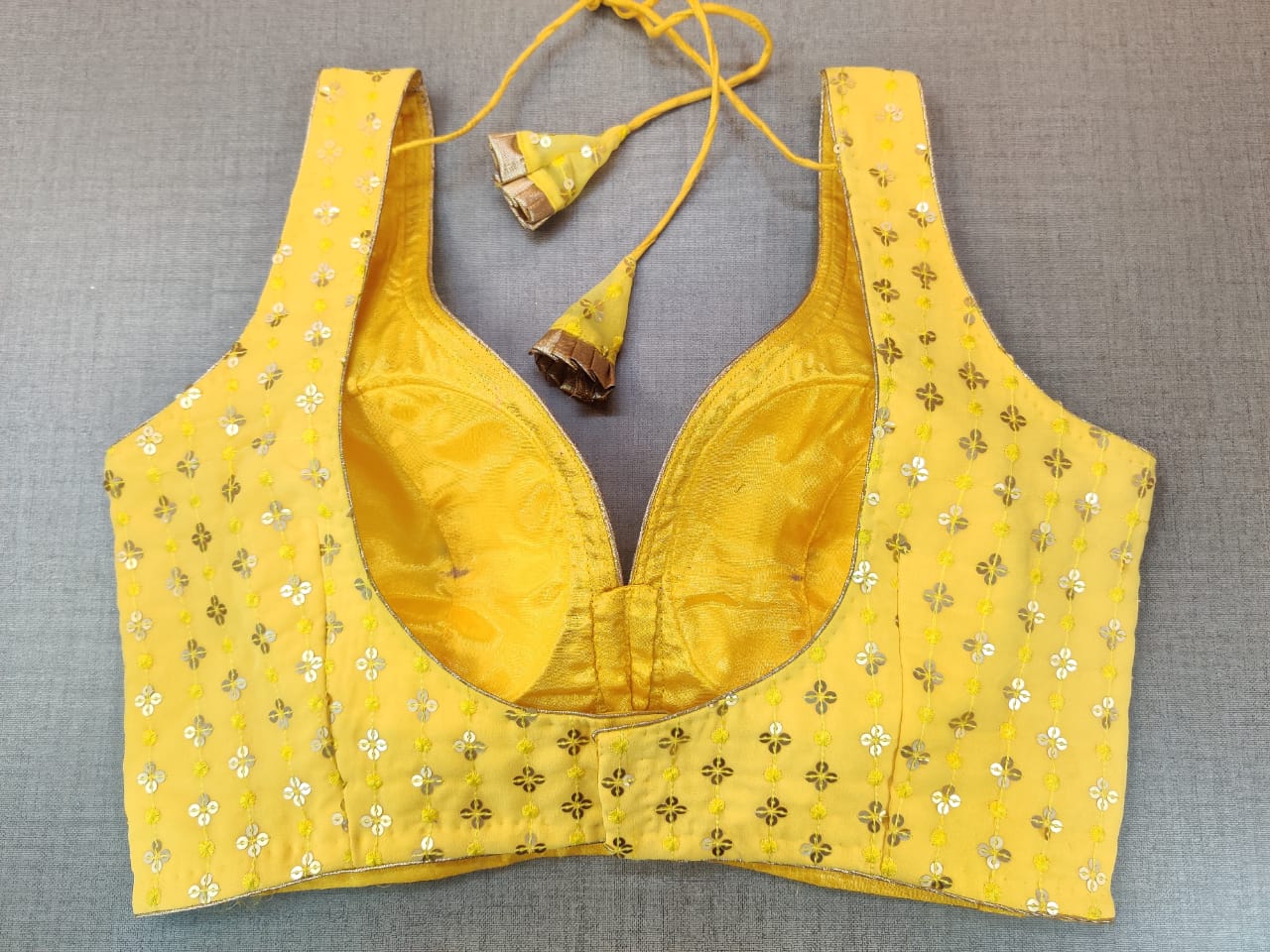 Buy beautiful yellow sleeveless sari blouse online in USA with golden embroidery. Elevate your Indian ethnic sari looks with exquisite readymade saree blouse, embroidered saree blouses, Banarasi sari blouse, designer saree blouse from Pure Elegance Indian clothing store in USA.-back