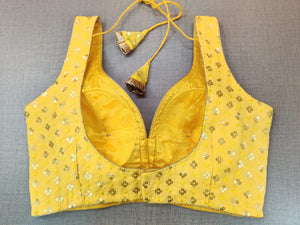 Buy beautiful yellow sleeveless sari blouse online in USA with golden embroidery. Elevate your Indian ethnic sari looks with exquisite readymade saree blouse, embroidered saree blouses, Banarasi sari blouse, designer saree blouse from Pure Elegance Indian clothing store in USA.-back