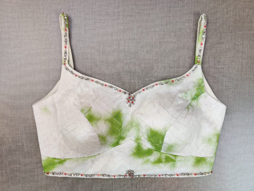 Shop stunning white and green embellished tie and dye saree blouse online in USA. Elevate your Indian ethnic saree looks with beautiful readymade saree blouse, embroidered saree blouses, Banarasi saree blouse, designer sari blouses from Pure Elegance Indian fashion store in USA.-front