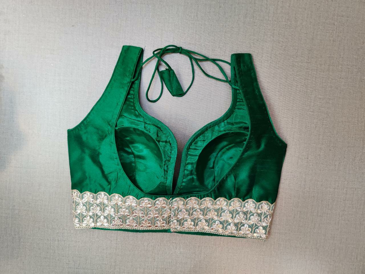 Buy beautiful bottle green sleeveless saree blouse online in USA with lace border. Elevate your Indian ethnic saree looks with beautiful readymade saree blouse, embroidered saree blouses, Banarasi saree blouse, designer saree blouses from Pure Elegance Indian fashion store in USA.-back