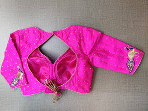 Shop stunning neon pink embroidered saree blouse online in USA with peacock motifs. Elevate your Indian ethnic saree looks with beautiful readymade sari blouse, embroidered saree blouses, Banarasi saree blouse, designer saree blouses, sleeveless saree blouses from Pure Elegance Indian fashion store in USA.-back