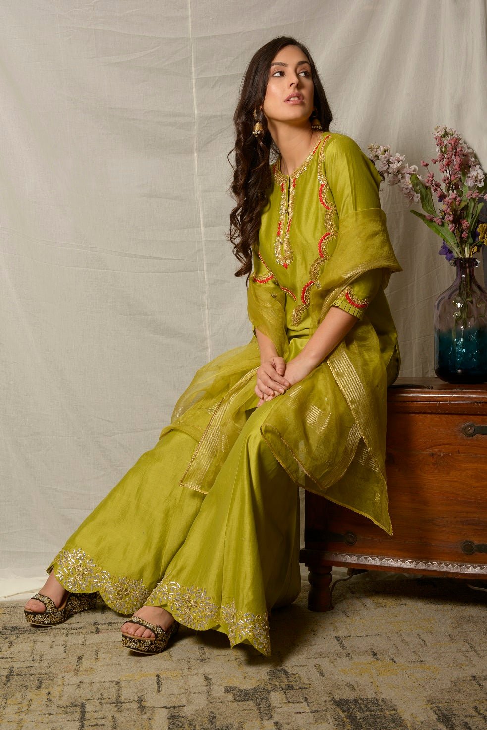 Shop beautiful pista green embroidered chanderi sharara suit online in USA with dupatta. Shine at weddings and special occasions with beautiful Indian designer suits, gowns, lehengas from Pure Elegance Indian clothing store in USA.-sitting