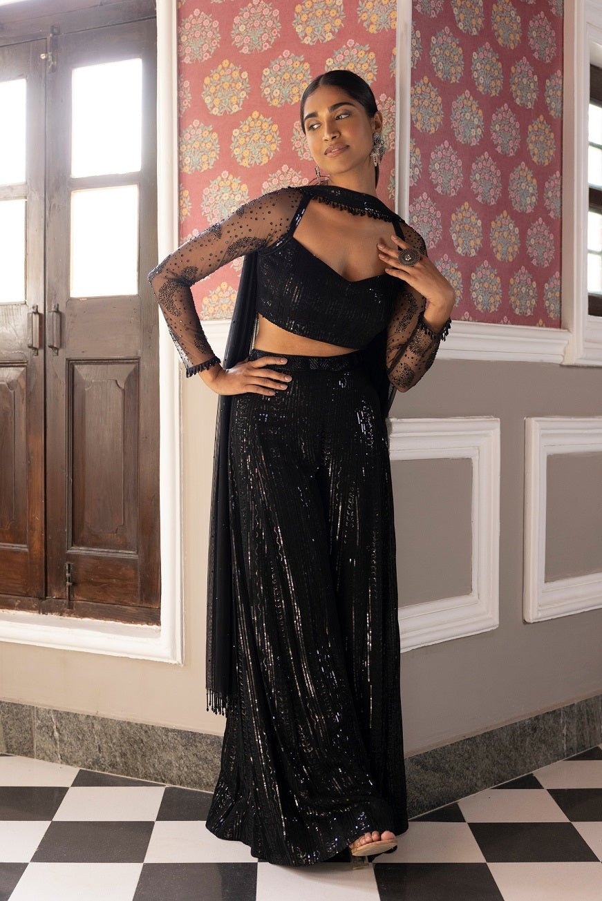 Shop beautiful black sequin work sharara set online in USA with dupatta. Dazzle on weddings and special occasions with exquisite Indian designer dresses, sharara suits, Anarkali suits, bridal lehengas, sharara suits from Pure Elegance Indian clothing store in USA.-front