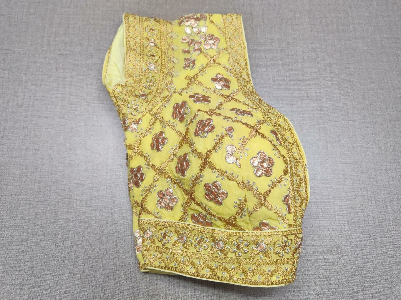 Buy this yellow color beautiful sequin designer blouse from Pure Elegance. A perfect go-to combination for your contemporary yet ethnic look. Elevate your Indian saree style with exquisite readymade sari blouse, embroidered saree blouses, Banarasi sari blouse, and designer sari blouse from Pure Elegance Indian clothing store in USA.-Folded View