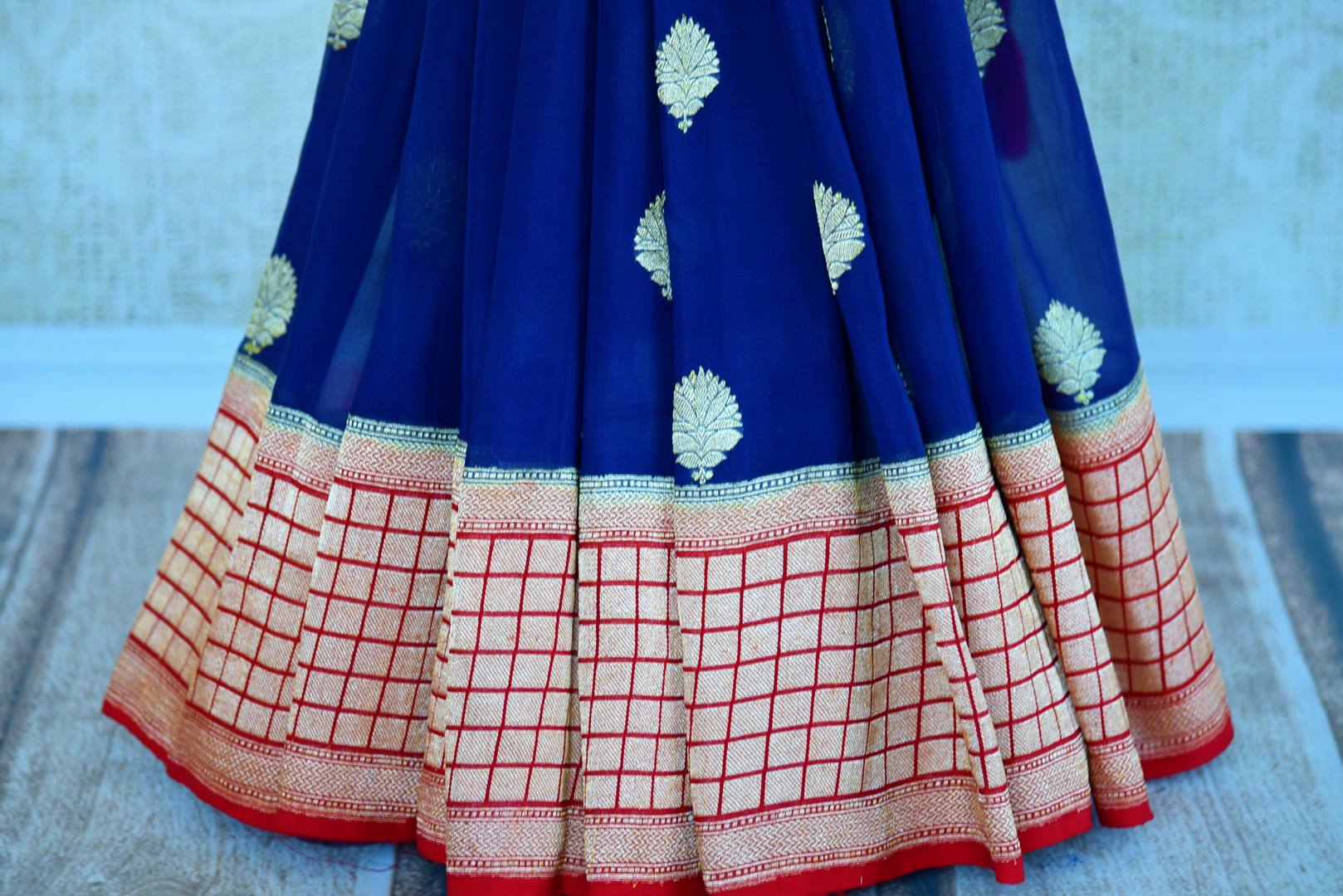 Buy blue georgette Banarasi saree with red border online in USA. Pure Elegance store brings an exquisite range of Indian Banarasi georgette sarees in USA for women.-pleats