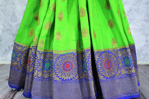 Striking neon green Muga Banarasi sari with zari buta buy online in USA. Explore a range of traditional Banarasi sarees in USA at Pure Elegance clothing store for women.-pleats