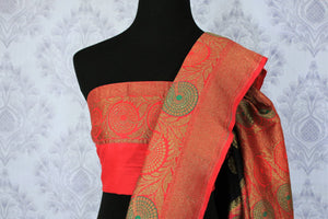 This black buta work muga banarsi silk sari complemented with a stunning red zari border and a heavily embroidered woven red pallu adds a touch of grace. Style it with a red designer blouse to strut at weddings or parties. Shop designer silk sarees, printed saris online or visit Pure Elegance store, USA. -blouse pallu