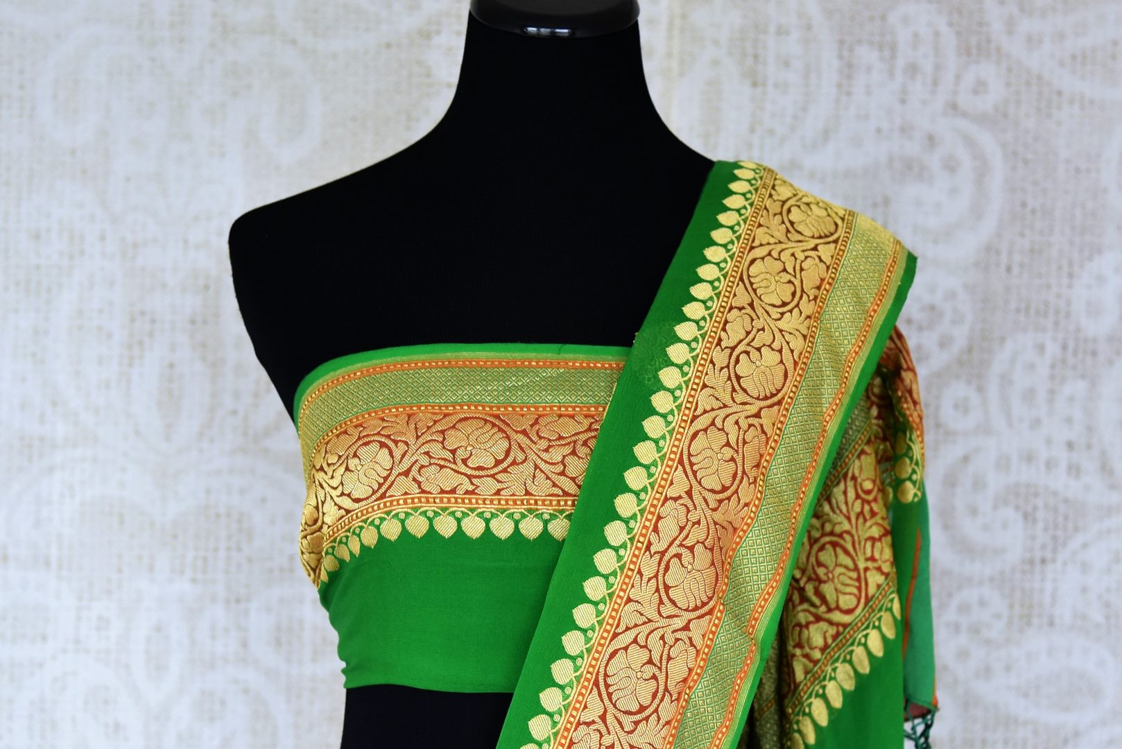 Shop green georgette Banarasi sari online in USA with floral zari buta and foliate zari border. Elevate your traditional saree style with beautiful Indian Banarasi saris from Pure Elegance Indian fashion store in USA. We also have a stunning variety of bridal saris for Indian brides in USA. Shop now.-blouse pallu
