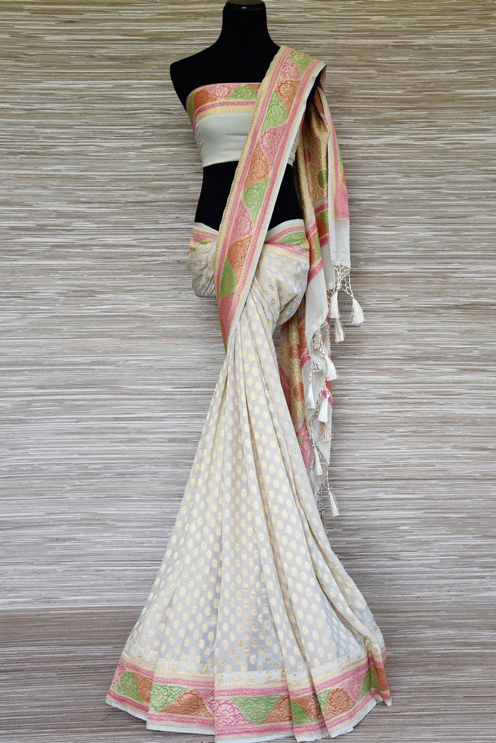 Buy cream georgette Banarasi sari online in USA with colorful zari border. Make your ethnic wardrobe colorful and rich with a splendid collection of Banarasi sarees from Pure Elegance Indian clothing store in USA. Shop online.-full view