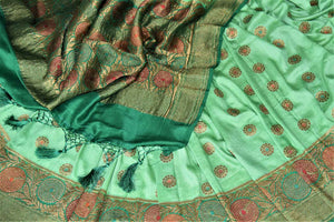 Buy pastel green muga Banarasi sari online in USA with dark green antique zari floral border. Keep your ethnic style updated with latest designer sarees, handloom sarees, pure silk sarees from Pure Elegance Indian fashion store in USA.-details