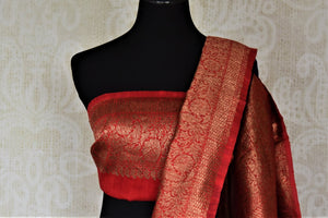 Shop indigo blue tussar Banarasi saree online in USA with zari buta and red antique zari border. Choose tasteful handloom saris for special occasions from Pure Elegance. Our exclusive Indian fashion store has a myriad of exquisite pure silk saris, tussar sarees, Banarasi sarees for Indian women in USA.-blouse pallu