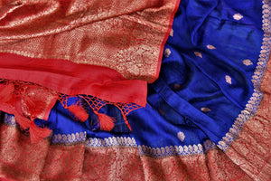Shop indigo blue tussar Banarasi saree online in USA with zari buta and red antique zari border. Choose tasteful handloom saris for special occasions from Pure Elegance. Our exclusive Indian fashion store has a myriad of exquisite pure silk saris, tussar sarees, Banarasi sarees for Indian women in USA.-details