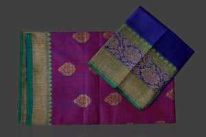Buy bluish purple tassar Benarasi saree online in USA with antique zari blue-green border and zari buta. Garner compliments on weddings and special occasions with exquisite Banarasi saris, handwoven silk sarees, tussar sarees from Pure Elegance Indian fashion store in USA.-flatlay