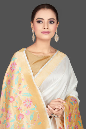 Buy beautiful white silk Katan saree online in USA with heavy zari floral minakari border. Look gorgeous on special occasions with exquisite Indian sarees, handwoven sarees, Banarasi sarees, pure silk sarees from Pure Elegance Indian saree store in USA.-closeup
