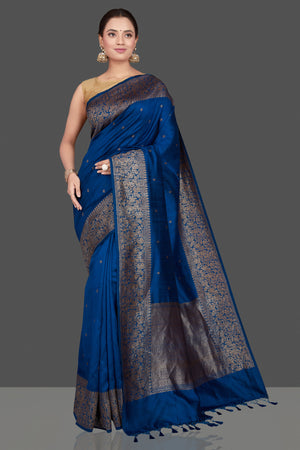 Buy stunning dark blue tussar Banarasi saree online in USA with antique zari buta border. Go for stunning Indian designer sarees, georgette sarees, handwoven saris, embroidered sarees for festive occasions and weddings from Pure Elegance Indian clothing store in USA.-front