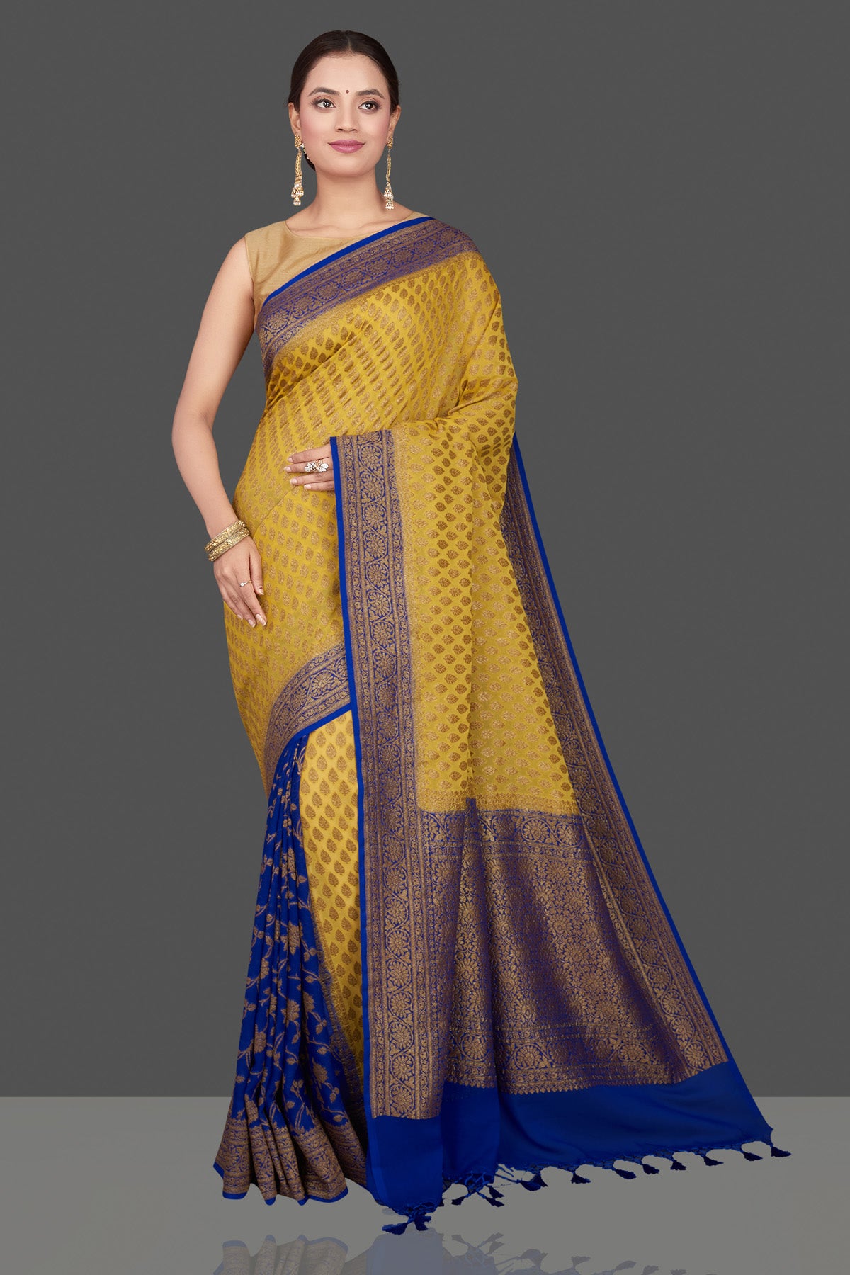 Buy stunning yellow georgette Banarasi saree online in USA with blue zari border. Get ready for festive occasions and weddings in tasteful designer sarees, Banarasi sarees, handwoven sarees from Pure Elegance Indian clothing store in USA.-front