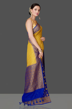 Buy stunning yellow georgette Banarasi saree online in USA with blue zari border. Get ready for festive occasions and weddings in tasteful designer sarees, Banarasi sarees, handwoven sarees from Pure Elegance Indian clothing store in USA.-side