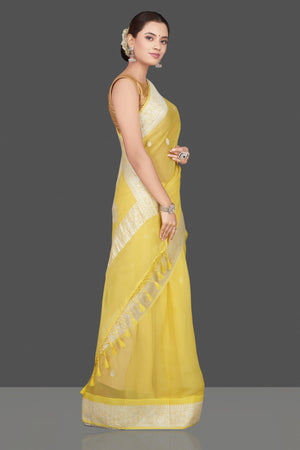 Shop charming yellow color chiffon georgette saree online in USA with silver zari border. Go for stunning Indian designer sarees, georgette sarees, handwoven saris, embroidered sarees for festive occasions and weddings from Pure Elegance Indian clothing store in USA.-side