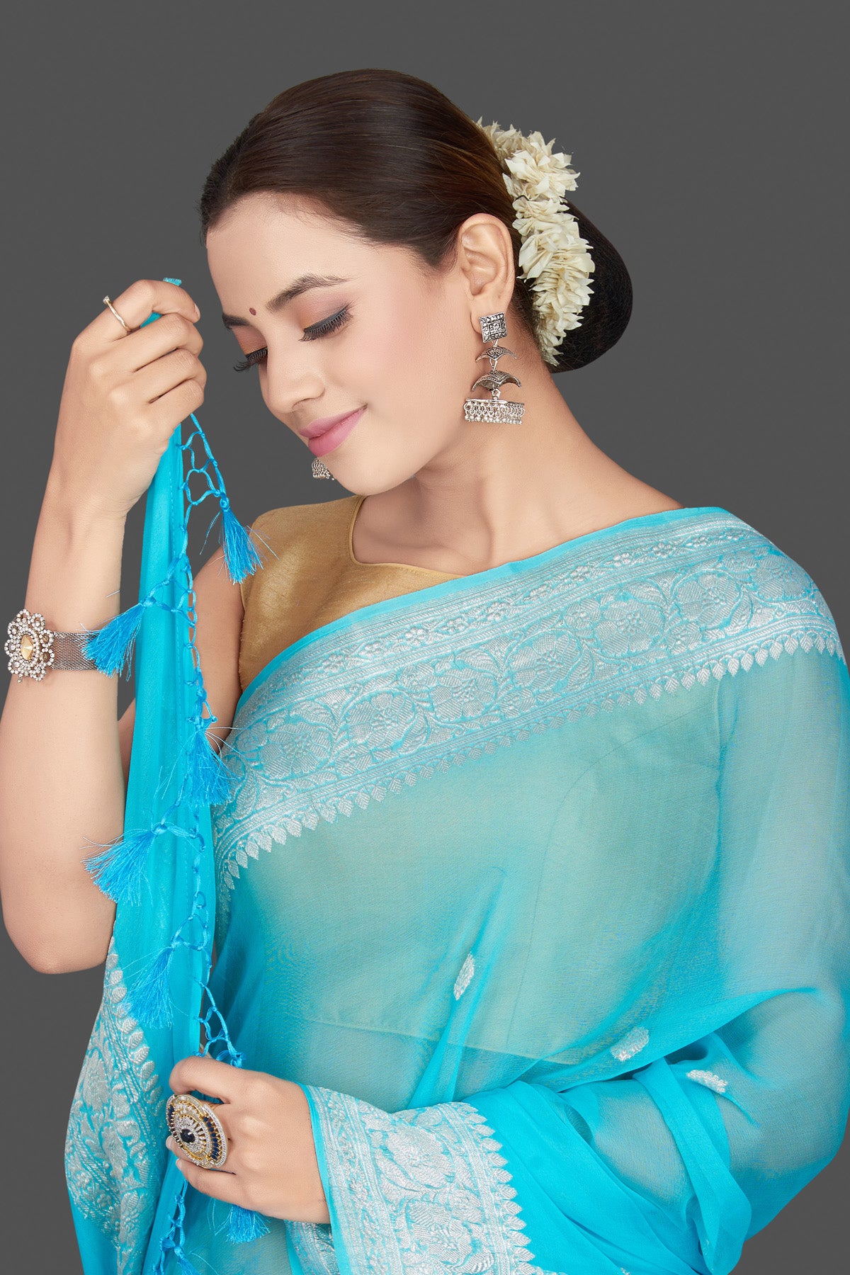 Buy beautiful sky blue chiffon georgette sari online in USA with silver zari border. Go for stunning Indian designer sarees, georgette sarees, handwoven saris, embroidered sarees for festive occasions and weddings from Pure Elegance Indian clothing store in USA.-closeup