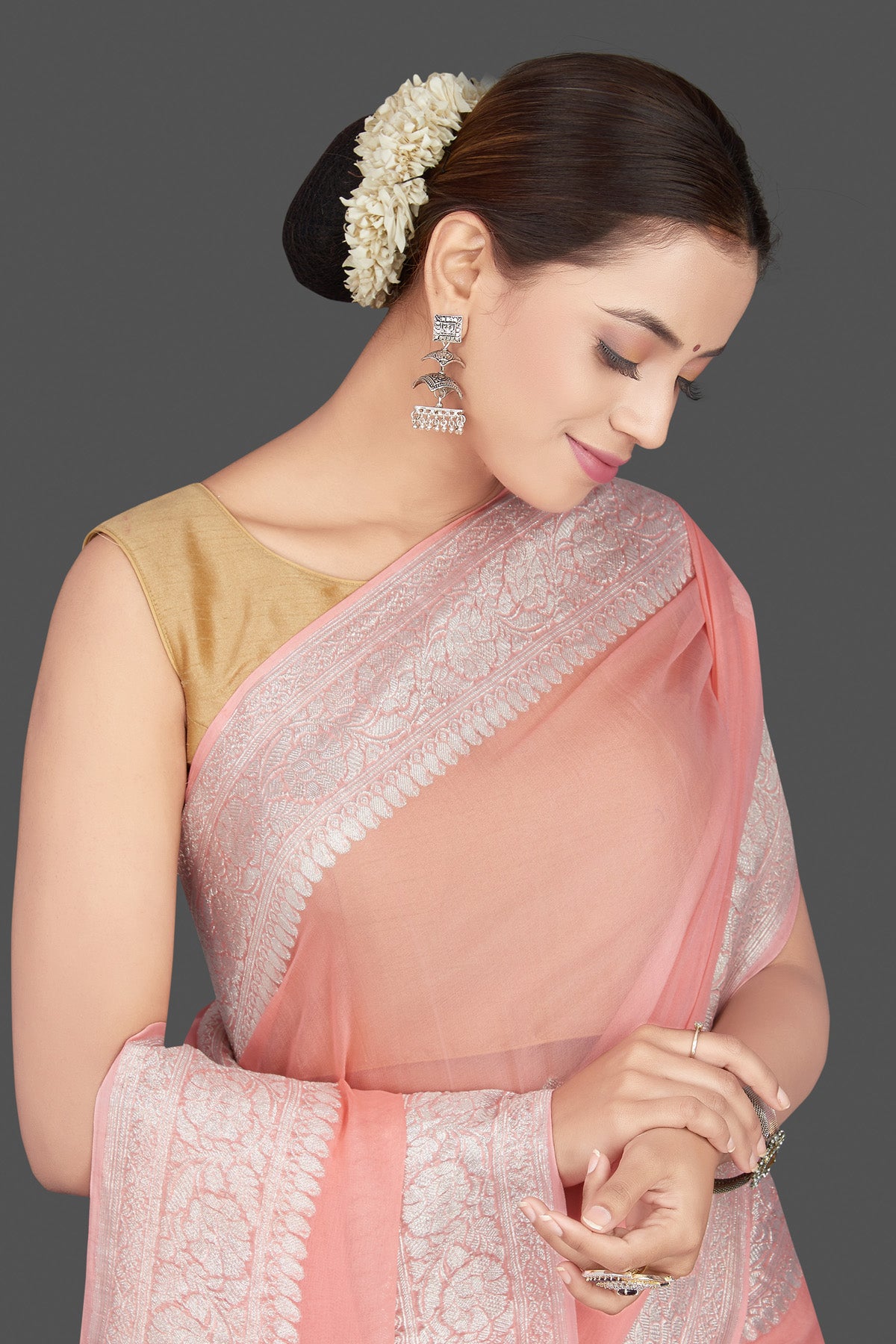 Shop stunning blush pink georgette chiffon sari online in USA with silver zari border. Go for stunning Indian designer sarees, georgette sarees, handwoven saris, embroidered sarees for festive occasions and weddings from Pure Elegance Indian clothing store in USA.-closeup