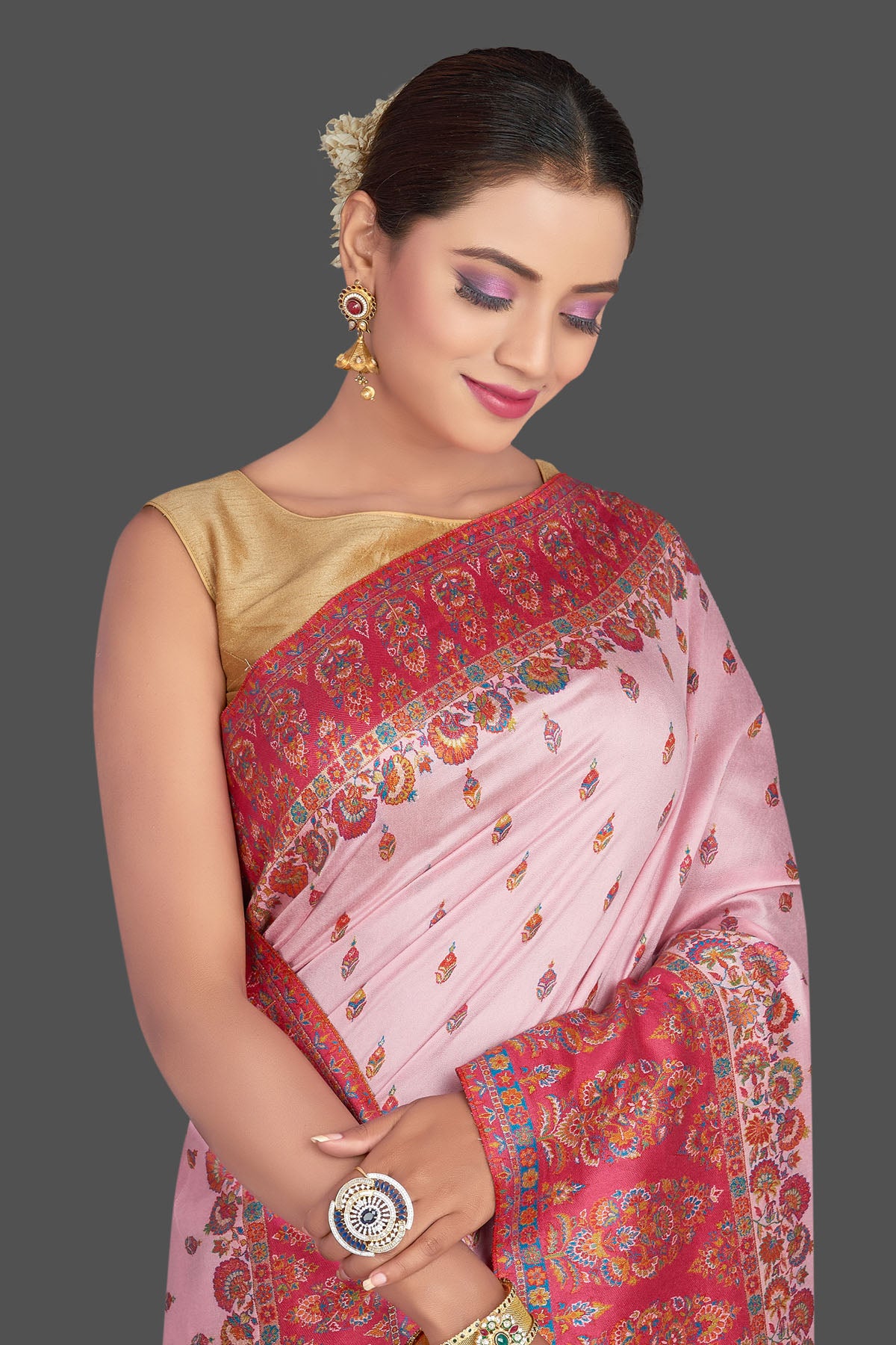 Shop stunning light pink Kani embroidery tussar silk saree online in USA. Make your presence felt on special occasions in beautiful embroidered sarees, handwoven sarees, pure silk saris, tussar sarees from Pure Elegance Indian saree store in USA.-closeup