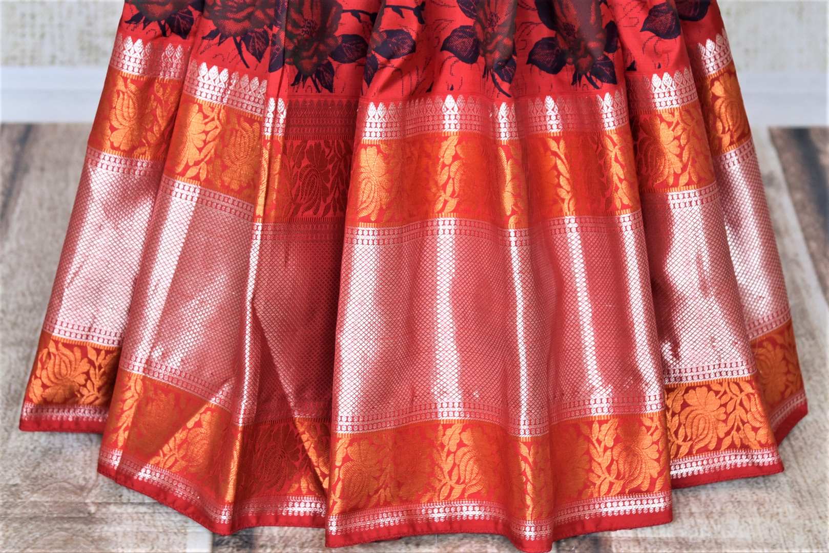 Buy gorgeous red floral print Gadhwal silk saree online in USA with golden zari border and zari pallu. Look attractive on special occasions in the beautiful silk sarees, designer saris, embroidered sarees, handwoven saris from Pure Elegance Indian fashion store in USA.-pleats