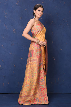 Shop stunning yellow Kani weave tussar muga silk saree online in USA. Buy latest designer sarees, handloom saris, embroidered sarees, Bollywood sarees, fancy sarees for special occasions from Pure Elegance Indian fashion store in USA. Shop soft silk sarees, pure Banarasi sarees, cotton sarees, georgette sarees. -side