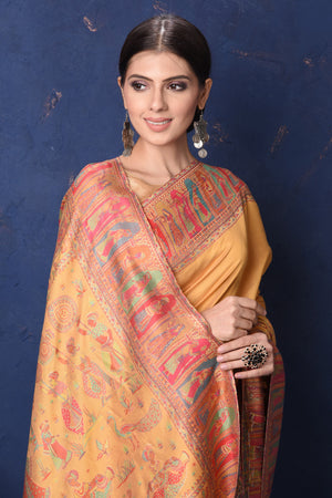 Shop stunning yellow Kani weave tussar muga silk saree online in USA. Buy latest designer sarees, handloom saris, embroidered sarees, Bollywood sarees, fancy sarees for special occasions from Pure Elegance Indian fashion store in USA. Shop soft silk sarees, pure Banarasi sarees, cotton sarees, georgette sarees. -closeup