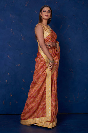Buy beautiful brown printed Kota saree online in USA with embroidered border. Keep your ethnic wardrobe up to date with latest designer sarees, pure silk sarees, handwoven sarees, tussar silk sarees, embroidered sarees from Pure Elegance Indian saree store in USA.-side