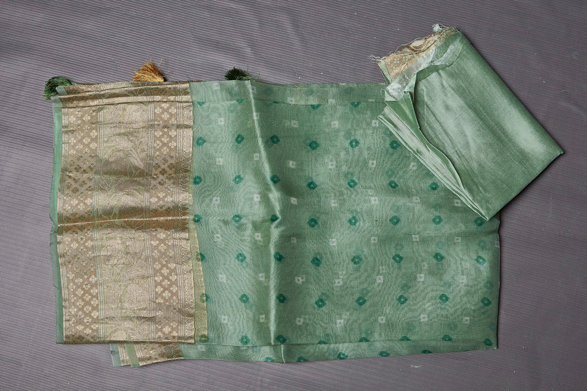 Buy stunning light green Bandhej print organza saree online in USA with golden zari border. Keep your ethnic wardrobe up to date with latest designer sarees, pure silk sarees, handwoven sarees, tussar silk sarees, embroidered sarees from Pure Elegance Indian saree store in USA.-blouse