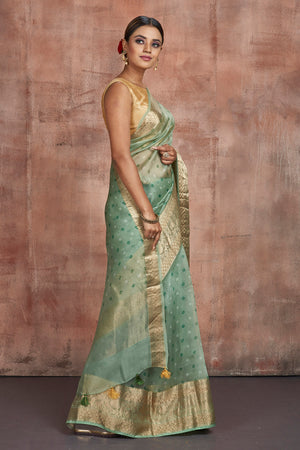Buy stunning light green Bandhej print organza saree online in USA with golden zari border. Keep your ethnic wardrobe up to date with latest designer sarees, pure silk sarees, handwoven sarees, tussar silk sarees, embroidered sarees from Pure Elegance Indian saree store in USA.-side