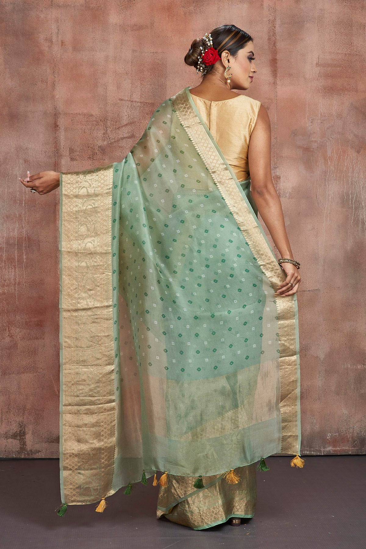 Buy stunning light green Bandhej print organza saree online in USA with golden zari border. Keep your ethnic wardrobe up to date with latest designer sarees, pure silk sarees, handwoven sarees, tussar silk sarees, embroidered sarees from Pure Elegance Indian saree store in USA.-back