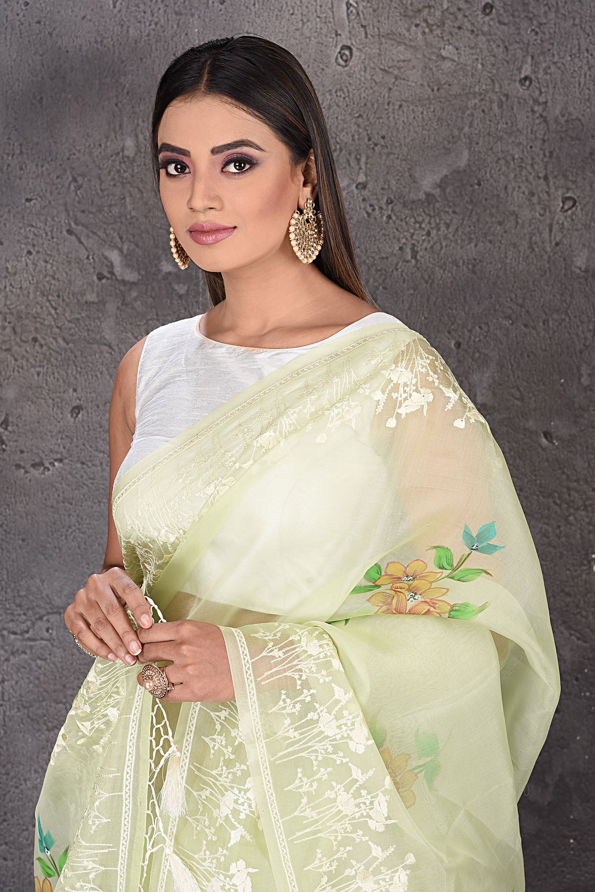 Shop stunning pastel green floral organza sari online in USA with embroidered border. Enrich your ethnic wardrobe with traditional Indian sarees, designer sarees. embroidered sarees, pure silk sarees, handwoven sarees, Kanchipuram sarees, Banarasi saris from Pure Elegance Indian saree store in USA.-closeup