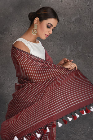 Buy stunning maroon striped handloom cotton saree online in USA. Keep your ethnic wardrobe up to date with latest designer sarees, pure silk sarees, handwoven sarees, tussar silk sarees, embroidered sarees, organza saris from Pure Elegance Indian fashion store in USA.-closeup