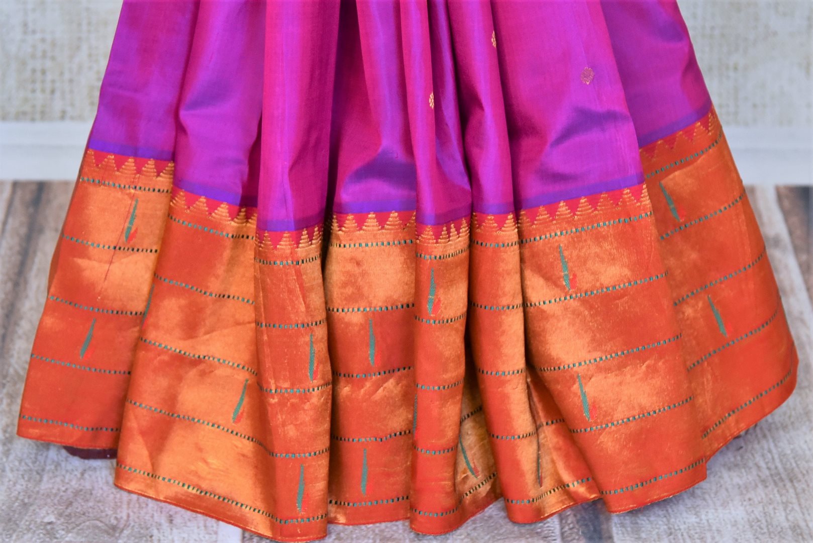 Shop stunning purple handloom silk Paithani saree online in USA with red zari border. Flaunt your sartorial choices on special occasions in stunning designer sarees, embroidered sarees, handloom sarees, Banarasi sarees, crepe sarees from Pure Elegance Indian fashion store in USA.-pleats