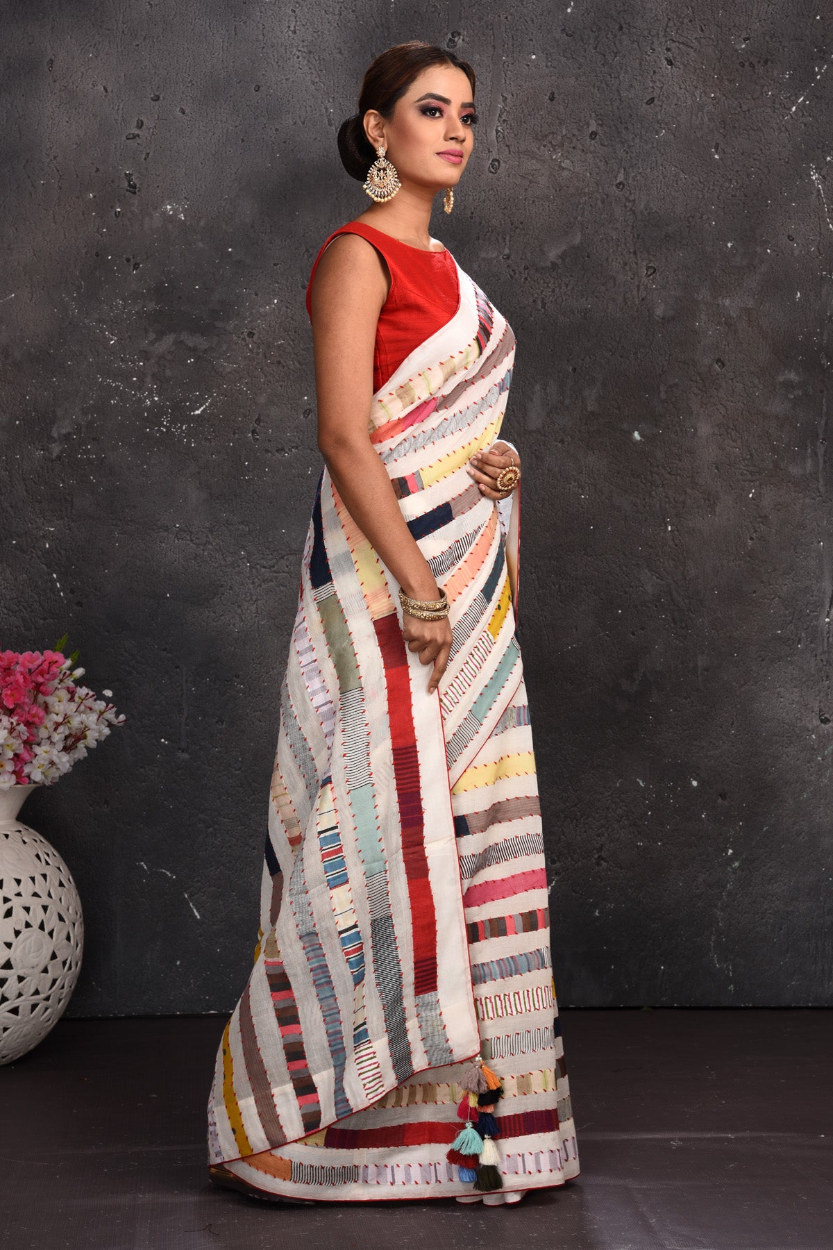 Buy beautiful off-white multicolor stripes applique linen sari online in USA. Keep your ethnic wardrobe up to date with latest designer sarees, pure silk sarees, handwoven sarees, tussar silk sarees, embroidered sarees from Pure Elegance Indian saree store in USA.-side