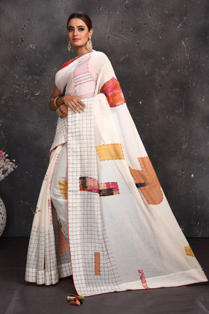 Buy beautiful off-white applique linen sari online in USA with check border. Keep your ethnic wardrobe up to date with latest designer sarees, pure silk sarees, handwoven sarees, tussar silk sarees, embroidered sarees from Pure Elegance Indian saree store in USA.-pallu