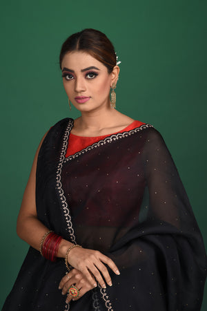 Shop this exquisite black saree in soft organza with heavy lace border online in USA which is made of organza fabric and lightweight. This organza Saree is beautified with lace work and latest trend. Ideal for casual, kitty parties, stylish accessories. Shop this from Pure Elegance Indian fashion store in USA.-Close up.