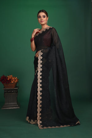 Buy this exquisite black saree in soft organza with heavy lace border online in USA which is made of organza fabric and lightweight. This organza Saree is beautified with lace work and latest trend. Ideal for casual, kitty parties, stylish accessories. Shop this from Pure Elegance Indian fashion store in USA.-Side view.