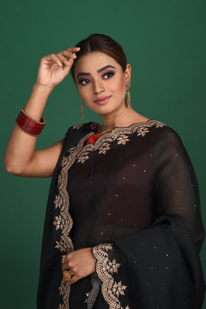 Buy this exquisite black saree in soft organza with heavy lace border online in USA which is made of organza fabric and lightweight. This organza Saree is beautified with lace work and latest trend. Ideal for casual, kitty parties, stylish accessories. Shop this from Pure Elegance Indian fashion store in USA.-Close up.