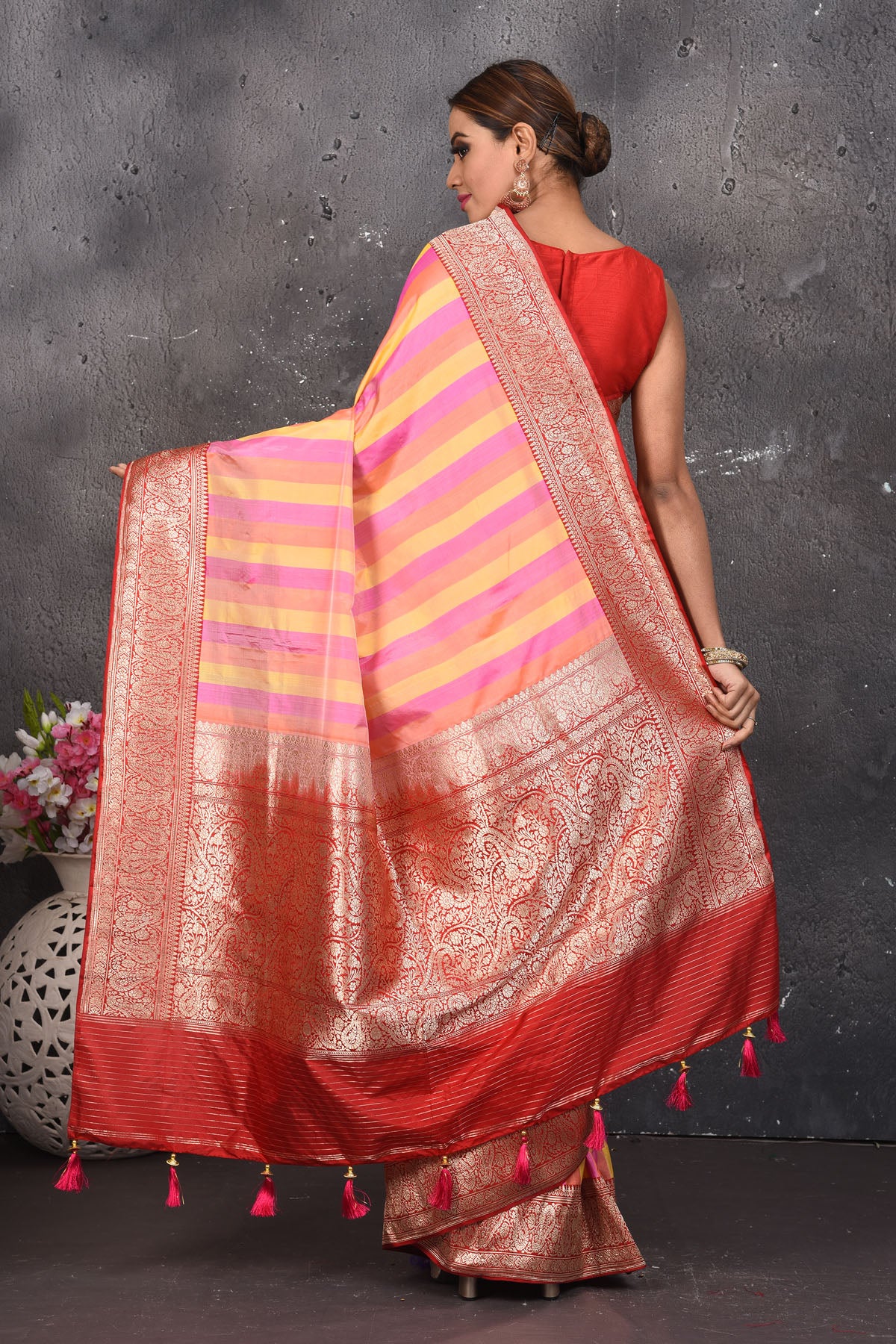 Buy this classy red banarasi silk brocade woven diagonal stripes and floral saree online in USA which has beautiful zari work all over the heavy border and end with handmade latkan. Pair this royal banarasi handloom brocade woven saree with your designer blouse and a potli bag from Pure Elegance Indian fashion store in USA.- Back view with open pallu.