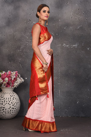 Shop this elegant peach pink sequins georgette saree with red-golden zari border online in USA. Create and establish a smashing influence on everybody by carrying this designer sequin georgette saree with your designer blouse. Shop designer sequins georgette with heavy border from Pure Elegance Indian saree store in USA.- Side view.